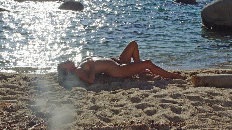 Aged MILF tanning her hot body on the nudist beach