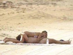 Nudist couple having oral sex on the beach