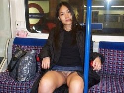 Asian MILF flashes the train with her pussy