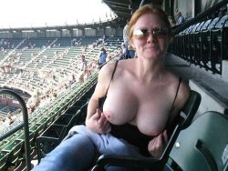Busty MILF flashes her tits at the stadium